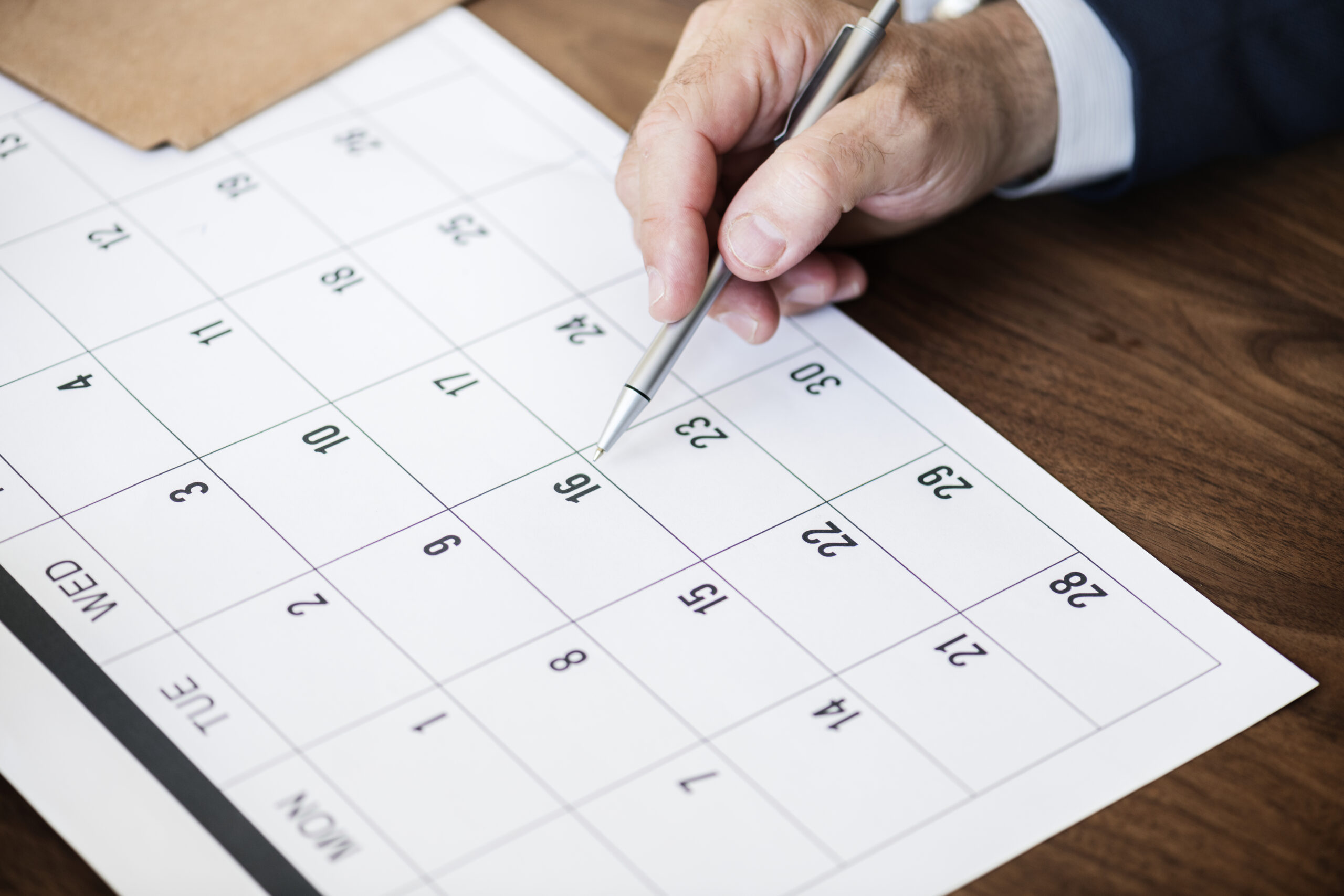 Businessman marking on calendar